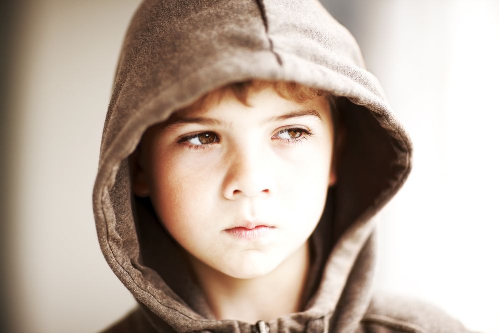 A young boy looks away.