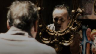 Anthony Stewart Head growls in the mirror as he sings in Repo! The Genetic Opera.