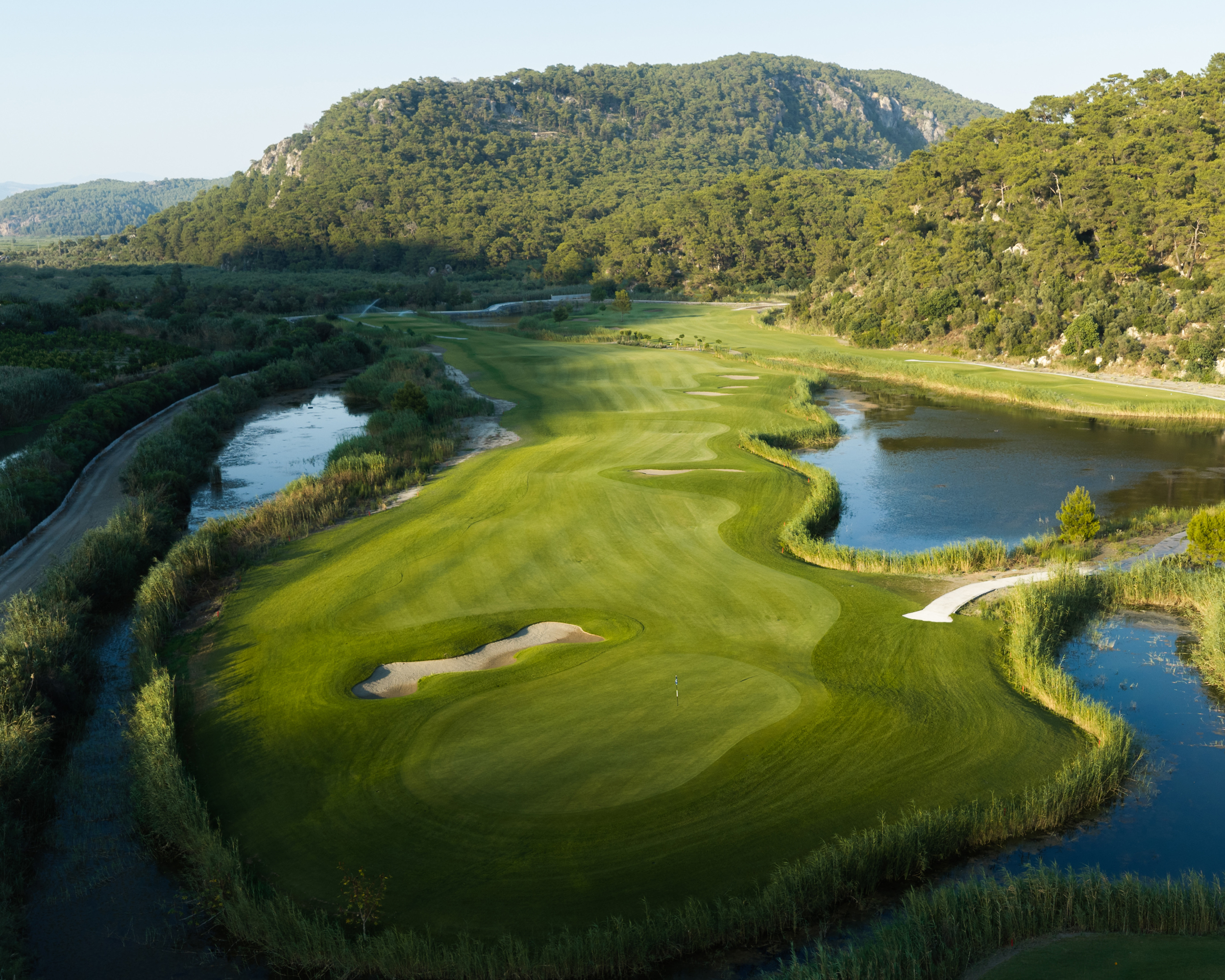 Looking down a hole at the Hilton Dalaman with mountains in the background