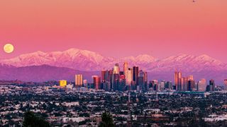 View across Los Angeles at sunset with Mount Baldy in the background