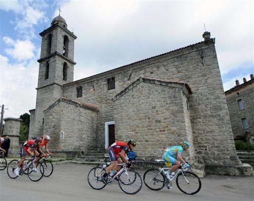 Lance Armstrong (RadioShack) passes a church on stage one of Criterium International
