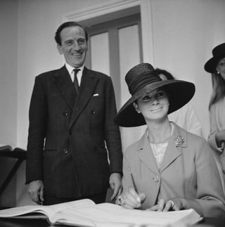 English fashion model and former Merchant Navy sailor April Ashley pictured signing the marriage register with her husband Arthur Corbett (1919-1993) on the day of their wedding in Gibraltar on 11th September 1963.