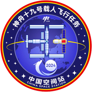 a patch showing a cross-shaped space station in orbit above Earth