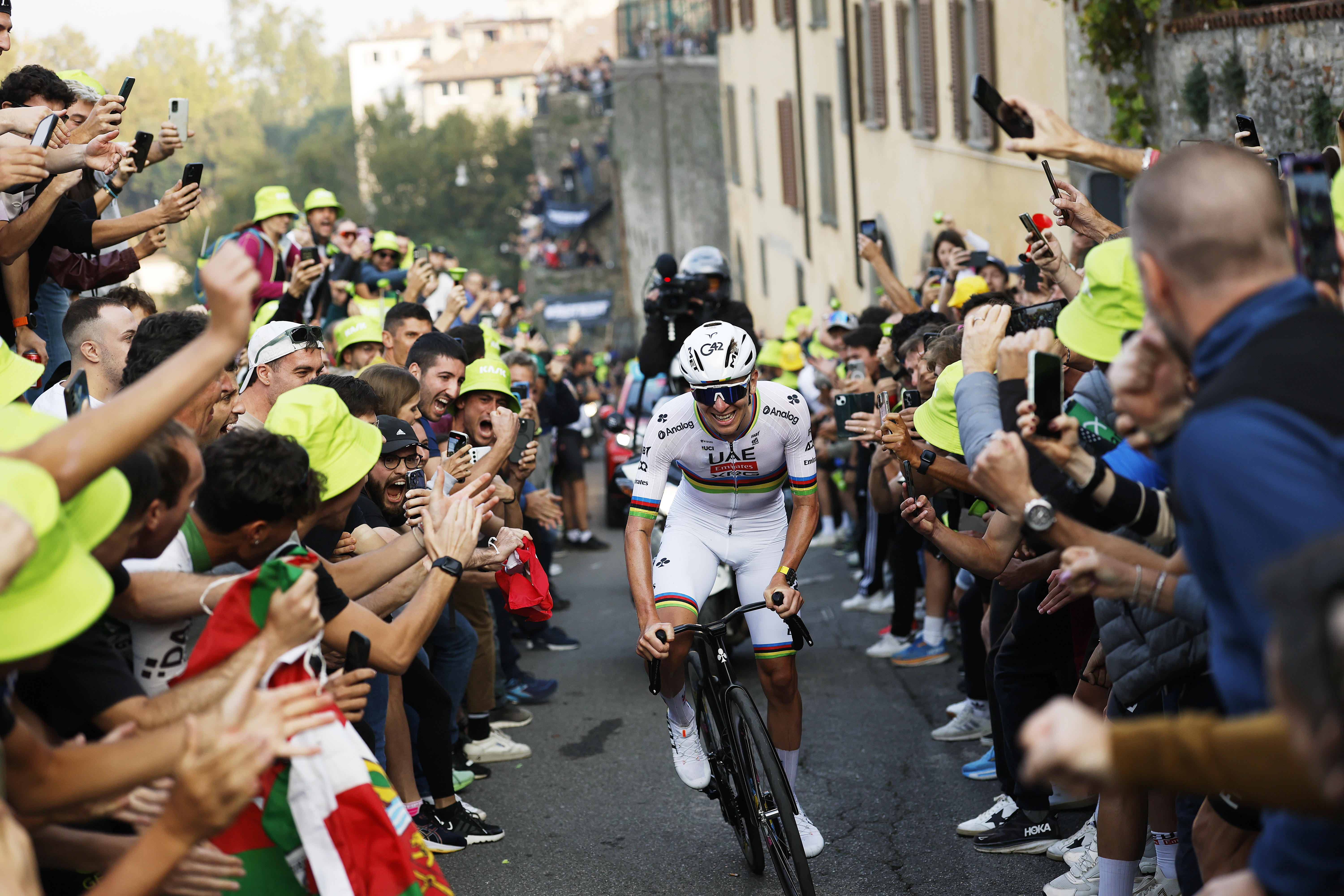 Tadej Pogačar rides through a crowd at Il Lombardia 2025