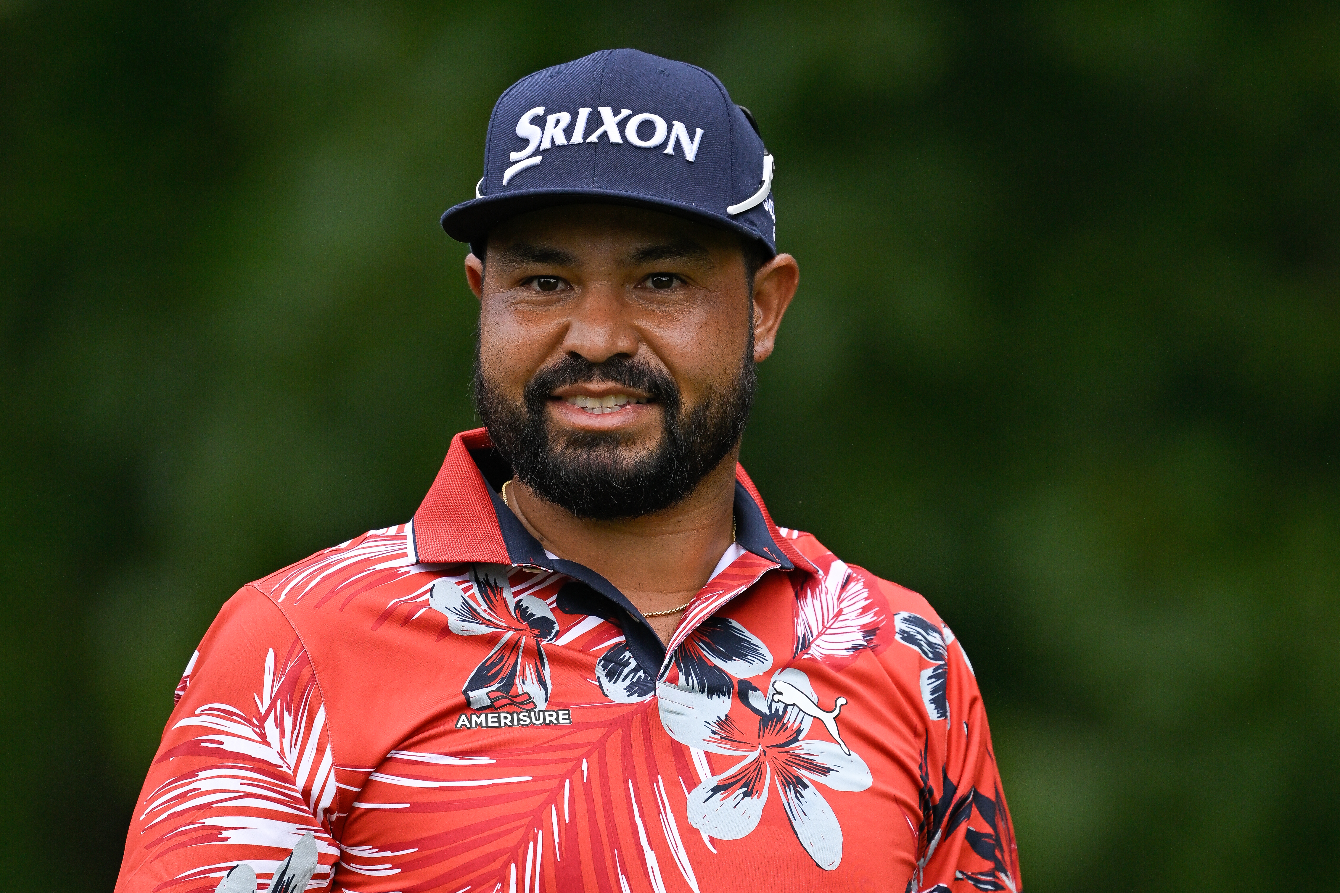 JJ Spaun smiles while looking towards the camera