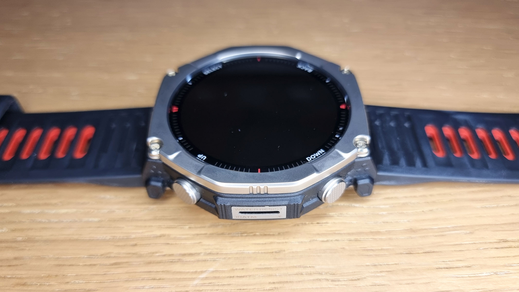a close-up picture of the Amazfit T-Rex Ultra 2 smartwatch laid flat on a table
