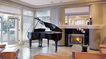 A grand piano sits in an elegant setting. Pianos are assets that can be put in a living trust.