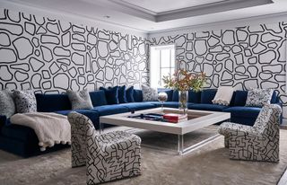 a living room with a black and white wallpaper