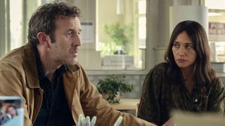 Couple holding each others hand in a medical office and looking worried