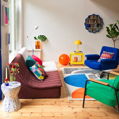 A colourful living room filled with pieces from Habitat's spring/summer 2025 collection including the Caliban XL globe light in orange placed on the floor