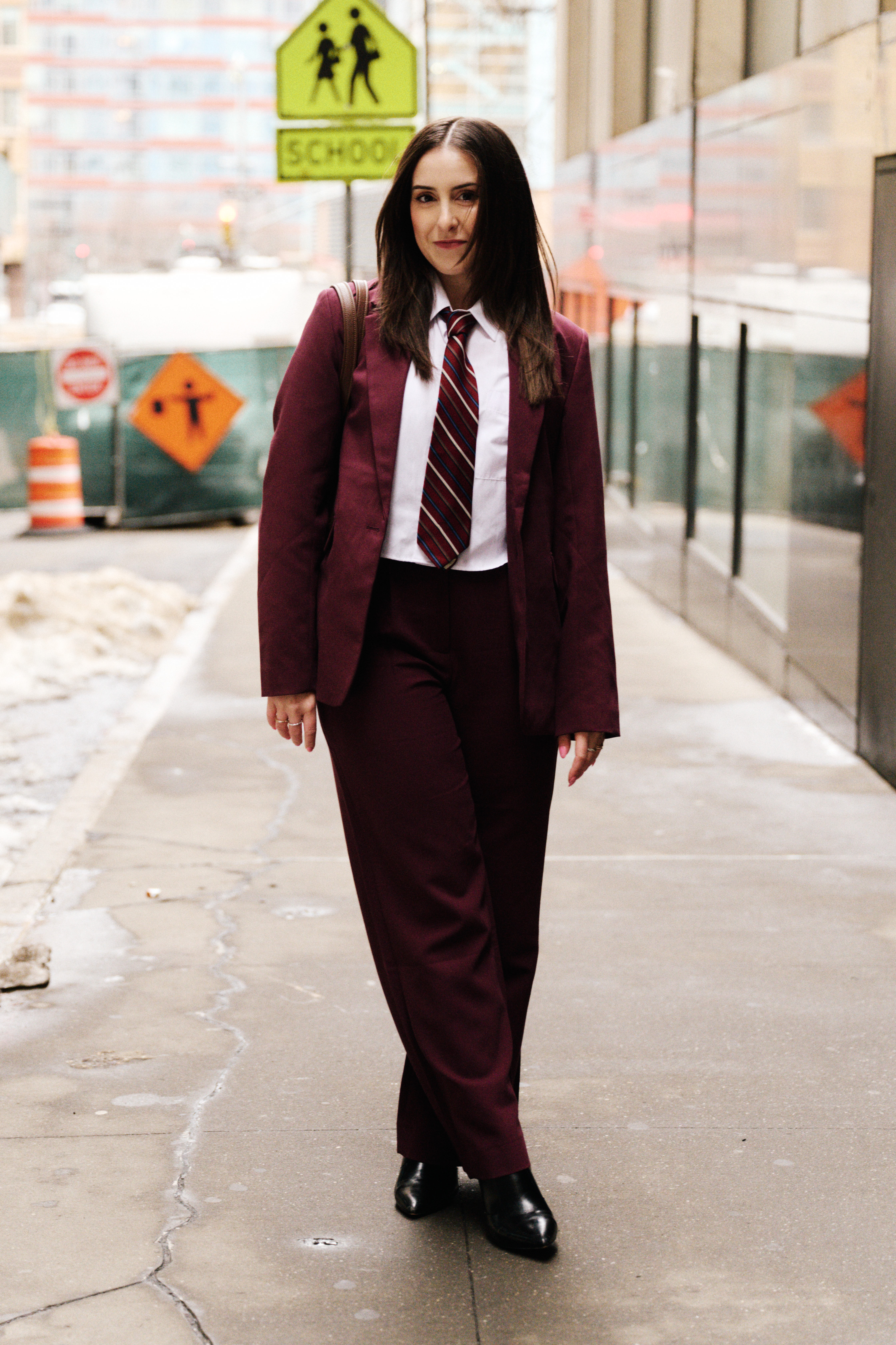 Christina Dambrosio wearing a necktie and a burgundy suit