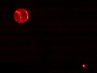 This shot, taken in infrared light using the adaptive optics system at Hawaii's Keck Observatory, shows Neptune and its moon Triton (lower right).