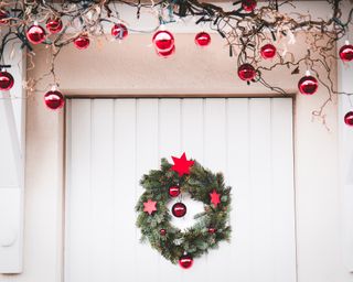 Christmas entrance door decoration white and red with christmas wreath