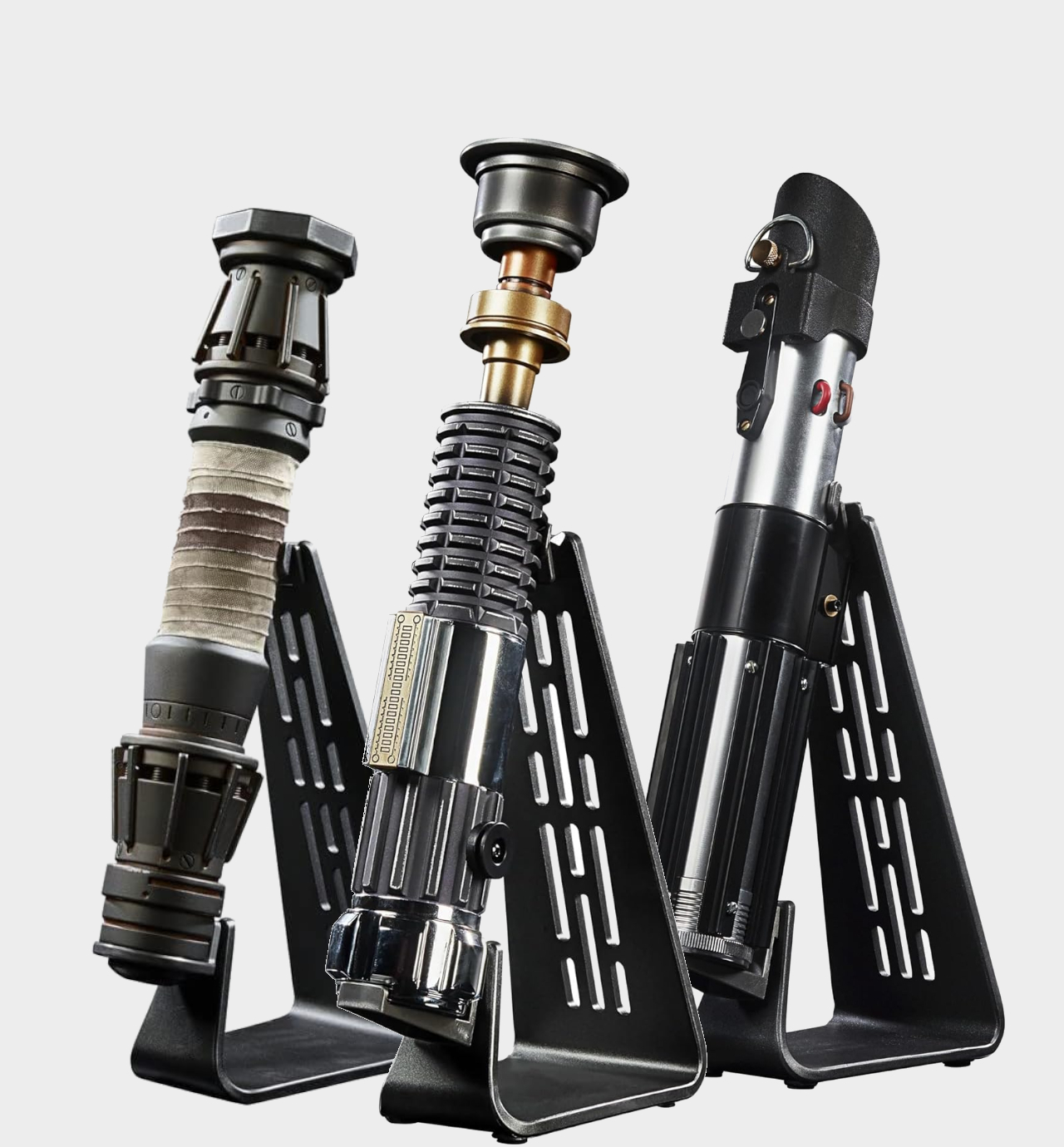 Star Wars The Black Series Rey, Obi-Wan, and Darth Vader hilts on display stands against a plain background