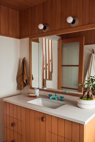 A wooden bathroom with wood panelled ceiling