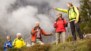 A hiking guide leads a group of hikers