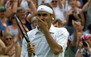 Roger Federer celebrates after winning his fourth round match against Pete Sampras at Wimbledon in 2001. It was the first time Sampras has lost a match at Wimbledon in five years. Pic: Gerry Penny/AFP/Getty Images