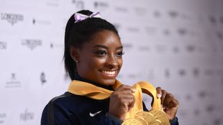 stuttgart, germany october 13 simone biles of usa poses with her medal haul after the apparatus finals on day 10 of the fig artistic gymnastics world championships at hanns martin schleyer hall on october 13, 2019 in stuttgart, germany photo by laurence griffithsgetty images