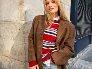 Sabina Socol in a red Reformation sweater and Gucci Jackie Bag.