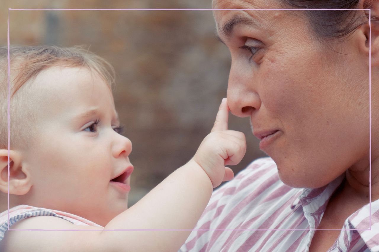 Baby pointing at mother&#039;s nose