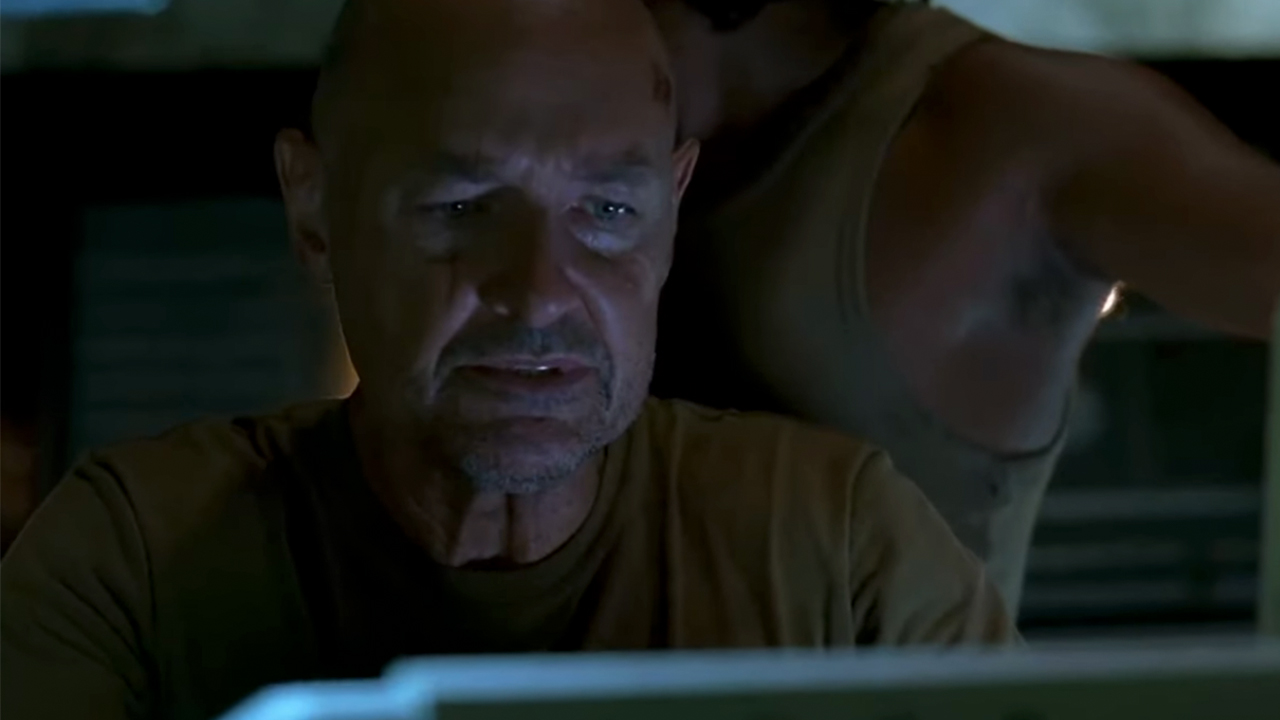 Terry O'Quinn as John Locke looking at a computer monitor in Lost.