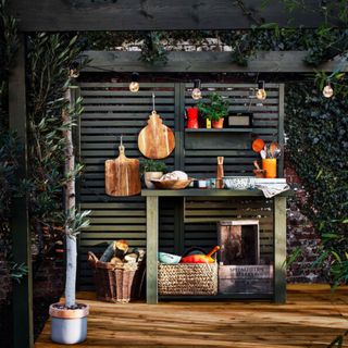 Painted freestanding fence with kitchen crockery and shelving