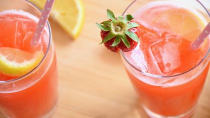 two strawberry lemonades with drinking straws