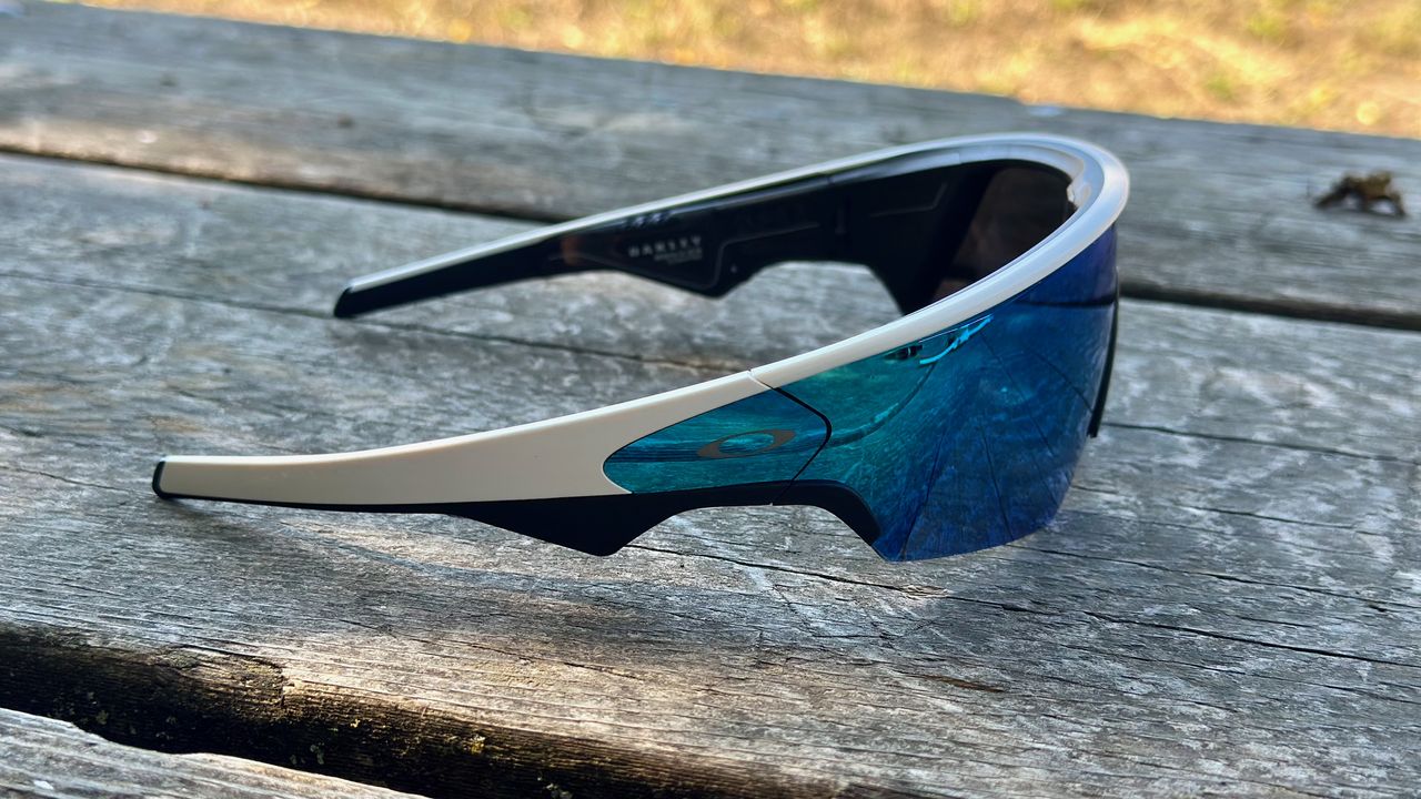 A top-side view of the Oakley Meta Vanguard smart glasses on a wooden table.