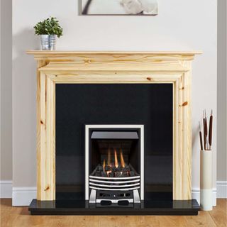 pine fireplace surround with stove in living room