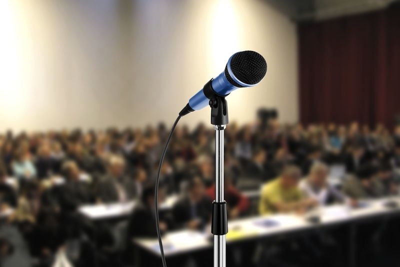 A microphone and large crowd.