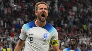 England captain Harry Kane celebrates after scoring a penalty against France at World Cup 2022.