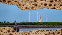 cracked pieces of matzah frame an orange rocket on the launchpad