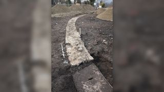 A plastered wall encloses the amphitheater's oval arena.