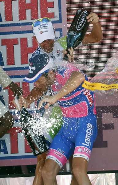 Michele Scarponi gets doused with champagne by compatriot Vincenzo Nibali.