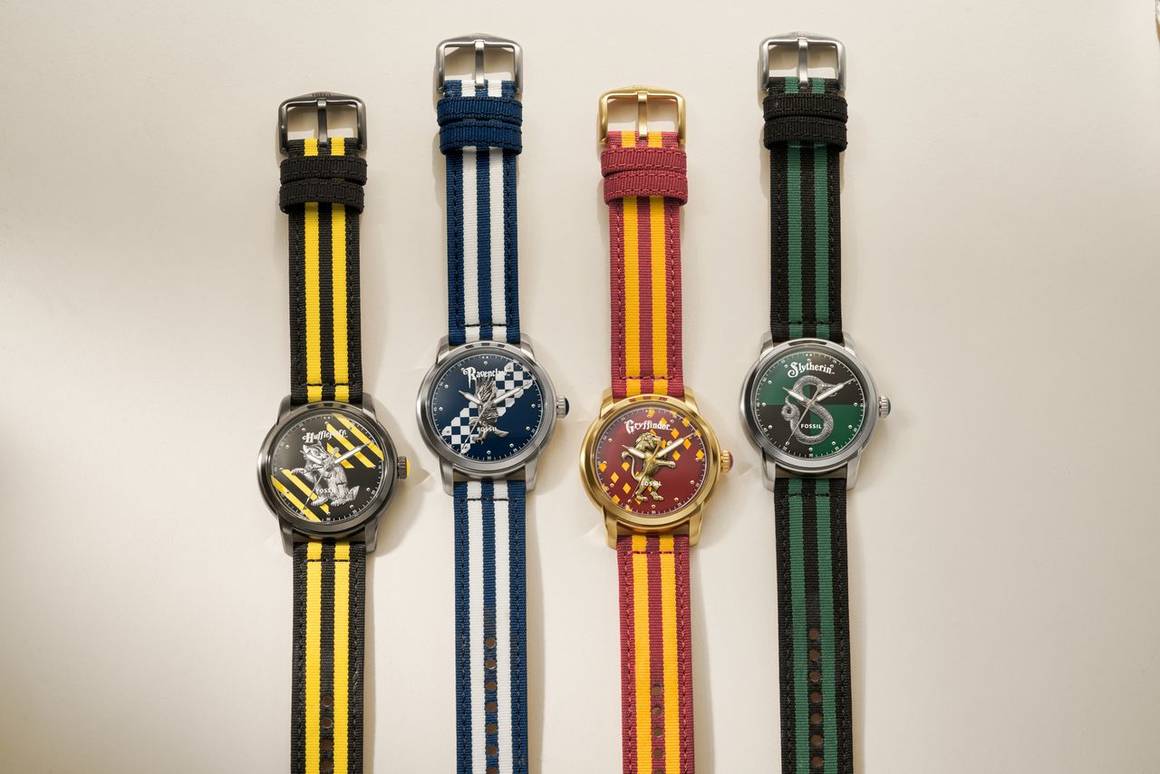 Four Harry Potter x Fossil watches, denoting each of the five Hogwarts houses, on a white background