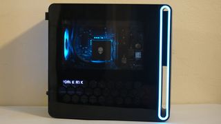 An Alienware Aurora gaming desktop on a desk seen from the side