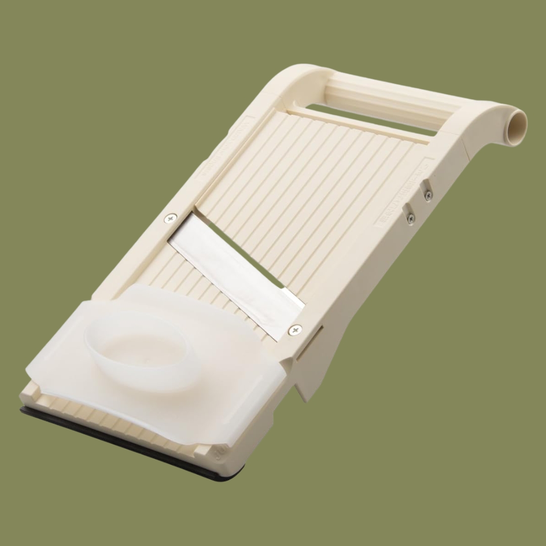 Benriner Mandoline BPA Jumbo Slicer With Handcrafted Japanese Stainless Steel Blade, 13 x 6.5 in beige against dark green background.