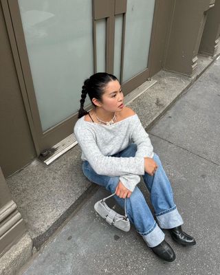 Content creator Allison Ho poses for a picture with her hair in a classic braid