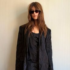 Daisy Edgar Jones wears a black linen minidress with a matching blazer and beige square-toe heels.