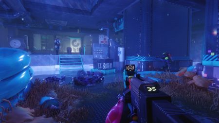 Players move through a blue room with guns ready in Marathon