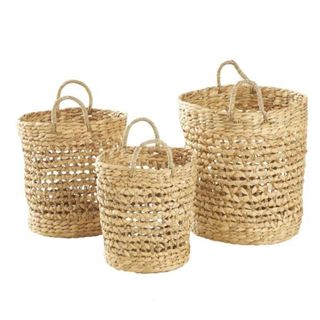 Sea grass woven baskets with handles in a set of three small medium and large on white background