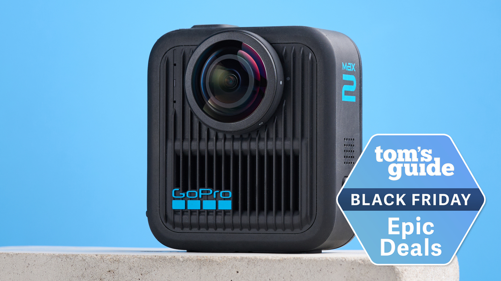 A GoPro MAX2 on a stone surface against a blue background with a Tom&#039;s Guide Black Friday deal badge in the bottom right corner of the image.