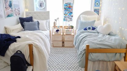 Two beds in white room with blue decorations