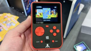 A photo from Gamescom 2024 showing a handheld gaming emulator device