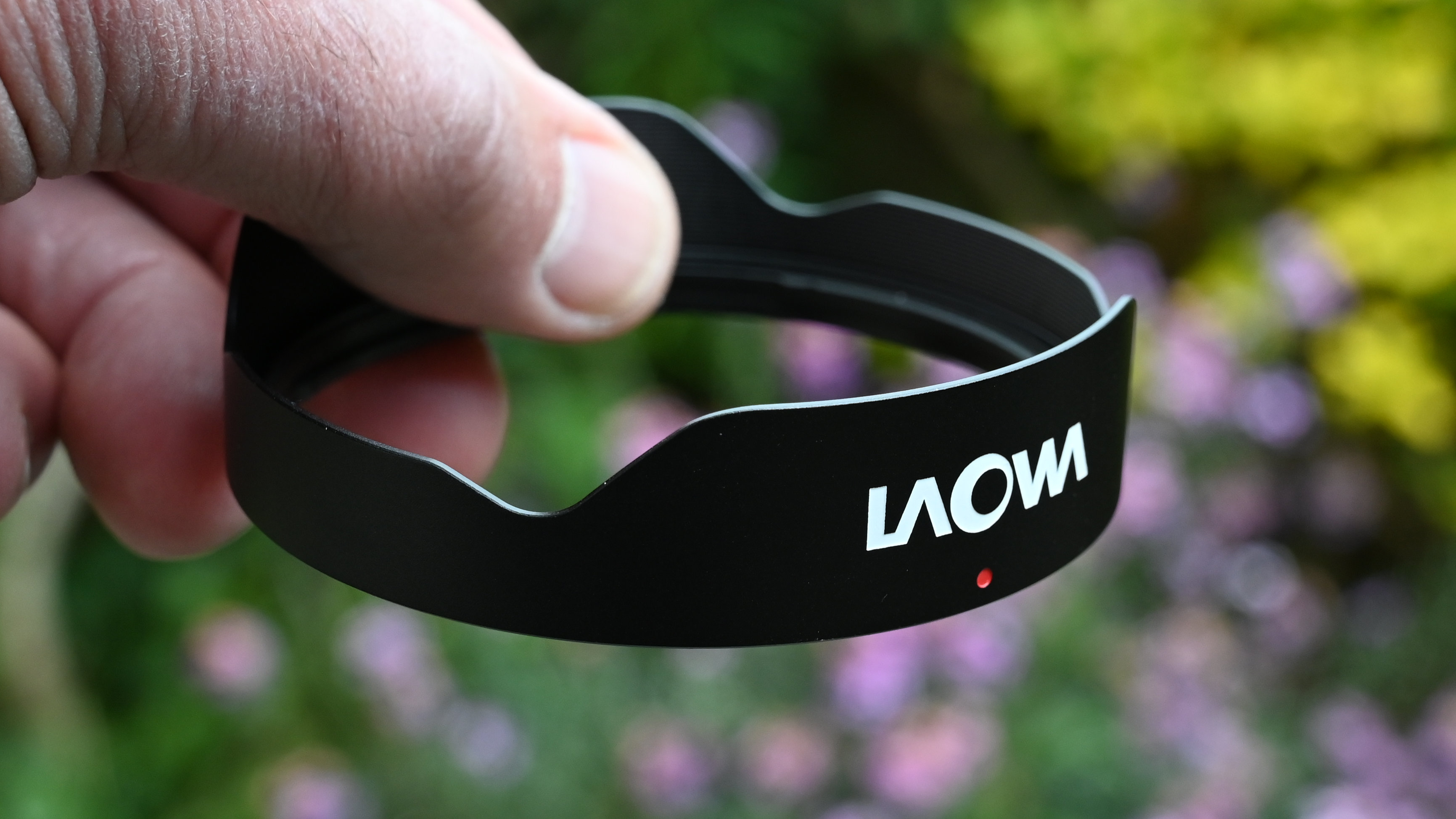 Laowa 15mm f/4.5 0.5x Macro product shot with lens held in hand