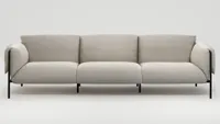 An outdoor sofa with cream upholstery and black metal frame