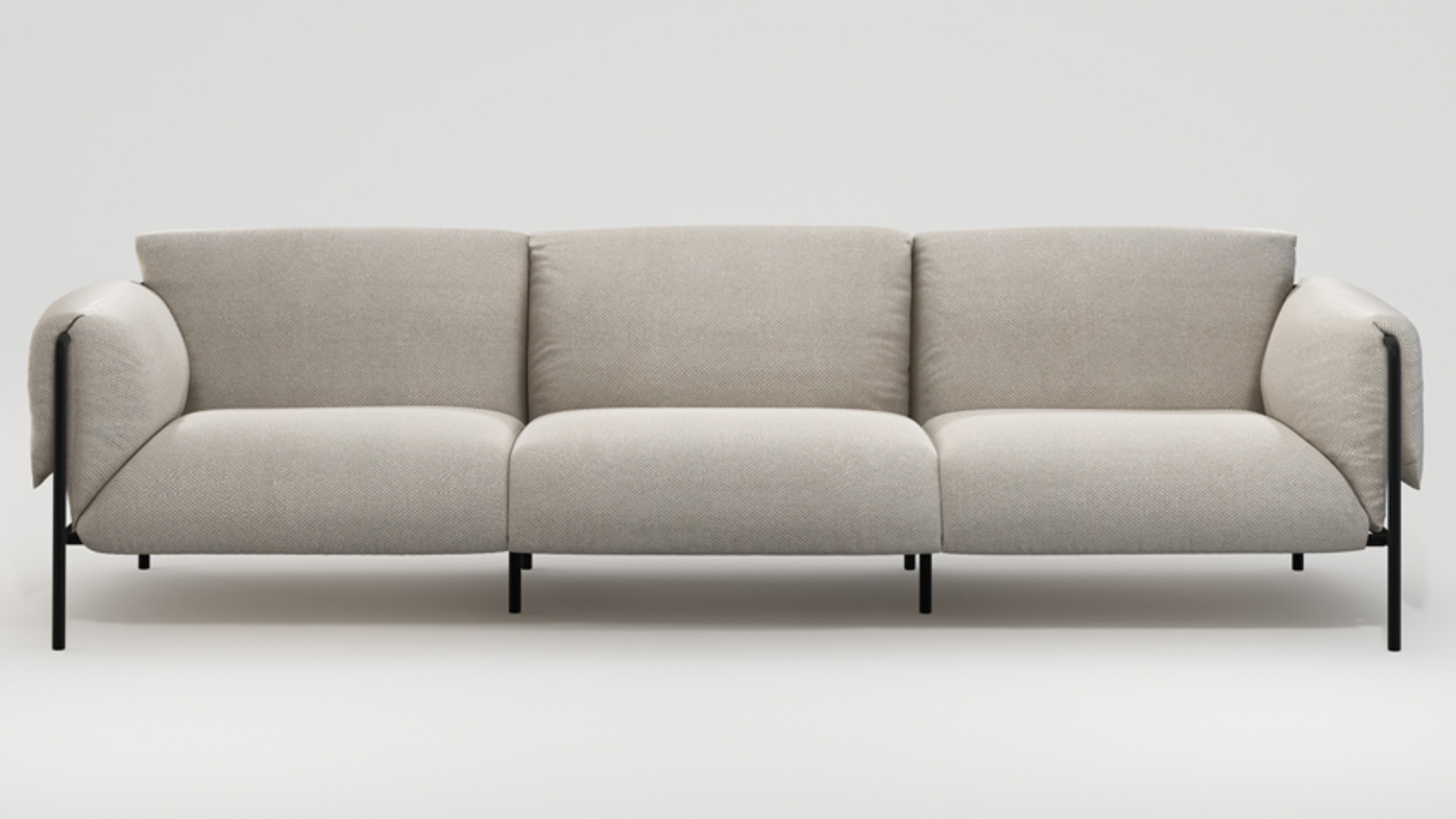 An outdoor sofa with cream upholstery and black metal frame
