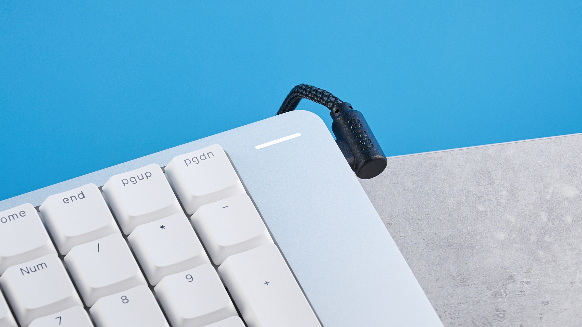 The Lofree Flow 2 on a stone surface with a blue background