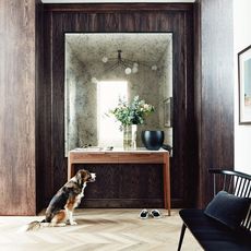 hallway with love seat and dog