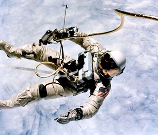 Ed White Spacewalks with Clouds in Background
